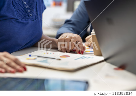 Senior man supporting his wife while they explore retirement plans with a broker, discussing future investment to secure pension and life savings. Professional insurance counseling. 118392834