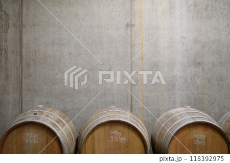 Wine cellar with oak barrels for aging wine. Traditional wine storage. 118392975