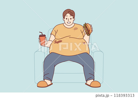 Fat man suffers from obesity caused by problem of overeating, sitting on sofa with burger and soda Fat man suffers from obesity caused by problem of overeating, sitting on sofa with burger and soda 118393313