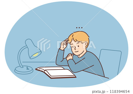 Boy child sit at desk reading book 118394654