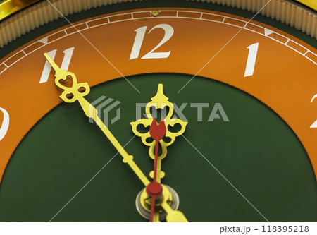 The clock shows the time of eleven hours and fifty-five minutes The clock shows the time of eleven hours and fifty-five minutes 118395218