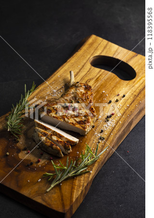 pork cutlet with a bone on rosemary and pepper pork cutlet with a bone on rosemary and pepper 118395568