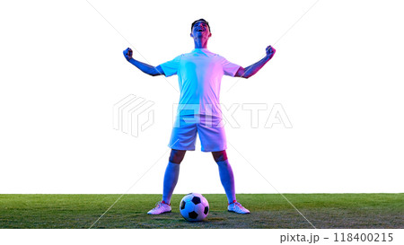 Young man dressed white sport uniform, clenching fists and shouting on joy, after successful game in neon light against white background. 118400215