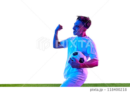 Football player wearing white uniform celebrates after successful goal green field and joy of victory framing his enthusiastic expression. 118400218