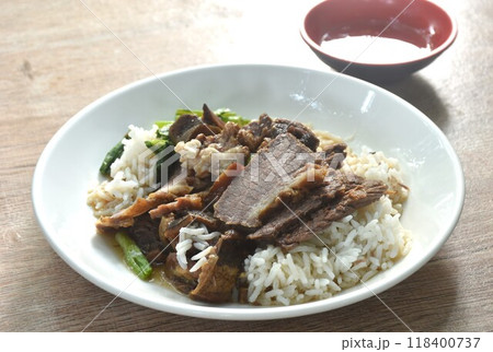 braised slice cow leg stew black Chinese herb soup eat couple boiled Chinese kale on plain rice in plate dipping spicy sour chili sauce braised slice cow leg stew black Chinese herb soup eat couple boiled Chinese kale on plain rice in plate dipping spicy sour chili sauce 118400737