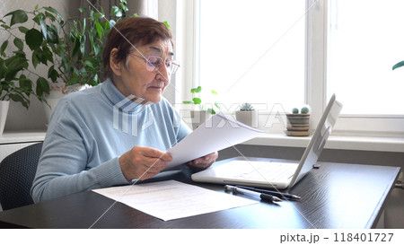 Elderly Woman Working with Documents 118401727