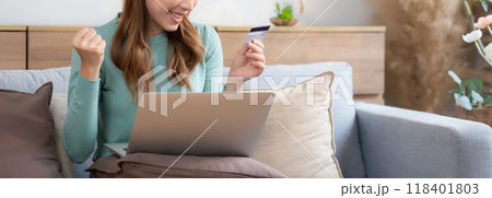 Young asian woman sitting on sofa using laptop computer shopping online with credit card. Young asian woman sitting on sofa using laptop computer shopping online with credit card. 118401803
