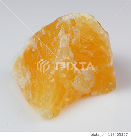 Enchanting Raw Yellow Calcite Crystal on Pristine White Background for Stock Photography Enchanting Raw Yellow Calcite Crystal on Pristine White Background for Stock Photography 118405397