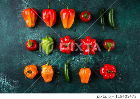 Colorful peper on green background Colorful peper on green background 118405478