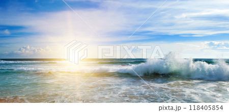 Sea and bright sun on blue cloudy sky. 118405854