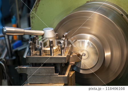 Closeup scene the lathe machine finish cut the metal parts in the light blue scene. Closeup scene the lathe machine finish cut the metal parts in the light blue scene. 118406108