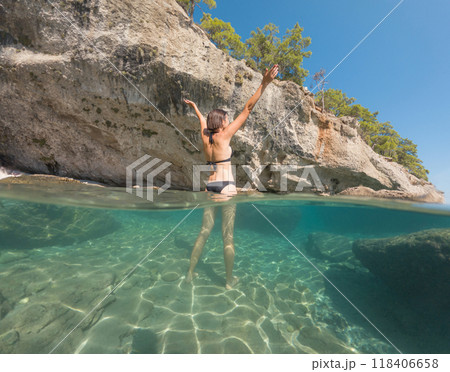 Woman on tropical vacation paradise on sea. Summer sea joy in Turkish seacoast, beaches along Lycian Way, Turkish Riviera. Asian female underwater and turquoise ocean around. 118406658