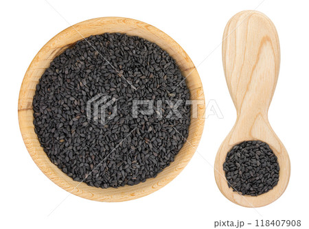 black sesame seeds in wooden bowl and spoon isolated on white background. Top view. Flat lay black sesame seeds in wooden bowl and spoon isolated on white background. Top view. Flat lay 118407908