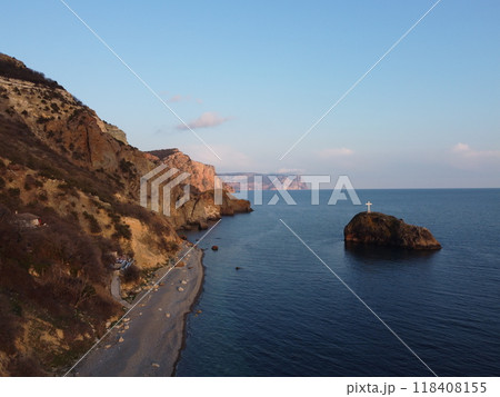 Aerial view from above on calm azure sea and pebbles beach. Small waves on cristal clear water surface in motion blur. Summer ocean sea beach background. Nobody. Holiday, vacation and travel concept 118408155