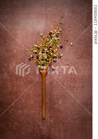 wooden spoon, with an assortment of legumes, beans, peas, top view, on a brown background, wooden spoon, with an assortment of legumes, beans, peas, top view, on a brown background, 118408681