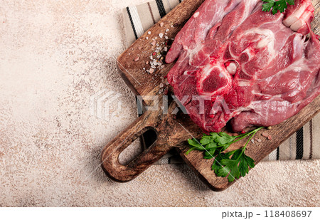 raw steak, veal neck on the bone, fresh meat, on a cutting board, with spices, top view, without people, raw steak, veal neck on the bone, fresh meat, on a cutting board, with spices, top view, without people, 118408697