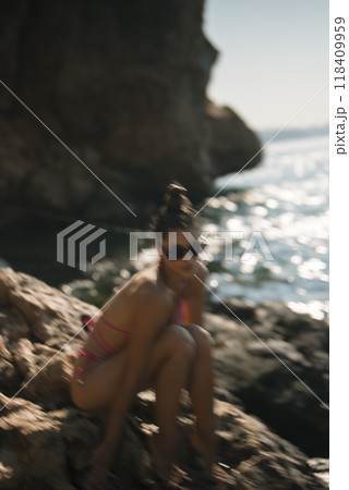 Enjoying a Truly Relaxing Beach Moment While Wearing Stylish Sunglasses Under the Bright Sun Enjoying a Truly Relaxing Beach Moment While Wearing Stylish Sunglasses Under the Bright Sun 118409959