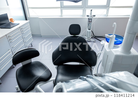 Modern dental clinic with advanced technology and clean equipment featuring an empty orthodontic chair 118411214
