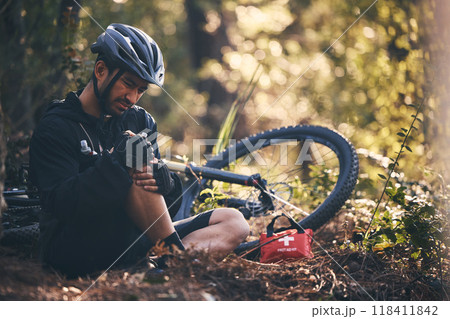 Sports man, injury and first aid outdoor while cycling on mountain bike in nature with leg or knee pain. Athlete person on ground in forest for fitness exercise, training or workout accident or fall 118411842