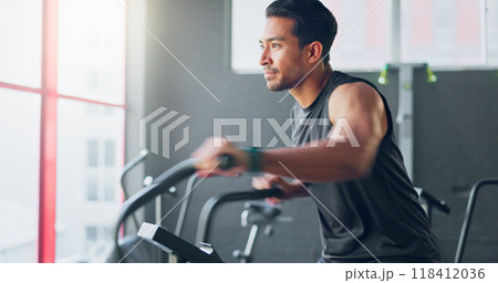 Man, cycling and training for fitness in gym with thinking, steps and vision for health, wellness and exercise. Person, bike and spin class with workout, ideas or endurance with cardio to lose weight 118412036