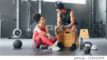 Personal trainer, woman and man with chart for exercise schedule, plan or check fitness progress in gym. Sports instructor, coach and checklist of people training for body health, workout or wellness 118412038