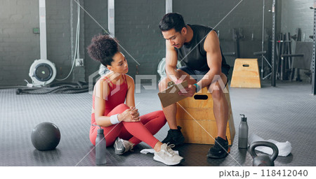 Personal trainer, woman and man with schedule for exercise, chart plan or check fitness progress in gym. Sports instructor, coach and checklist of people training for body health, workout or wellness 118412040