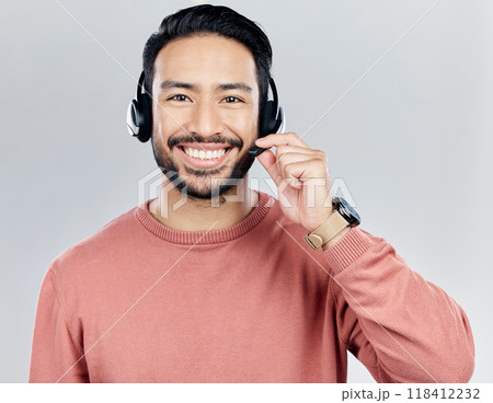 Asian man, portrait smile and headphones with mic for call center or online customer service against a white studio background. Happy male consultant with headset smiling for wireless communication Asian man, portrait smile and headphones with mic for call center or online customer service against a white studio background. Happy male consultant with headset smiling for wireless communication 118412232