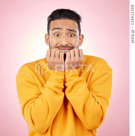 Anxiety, portrait and asian man biting nails in studio with terror, fear and shocking drama on pink background. Stress, gossip and face of male person with horror, fake news or worried about secret 118412268