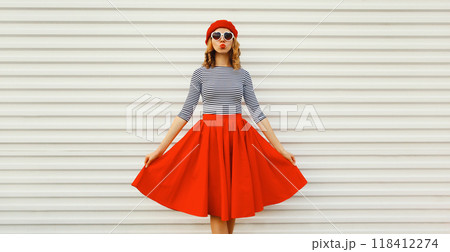 Beautiful happy smiling young woman, pretty girl in red skirt, french beret, heart shaped glasses 118412274