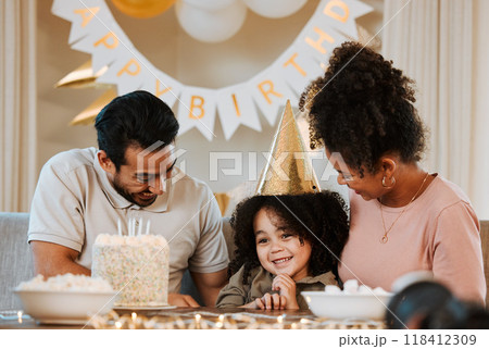 Father, mother and child at birthday party, cake and happy with celebration, care and bonding in family home. Dad, mom and young kid with event, excited face and smile together at table in house 118412309
