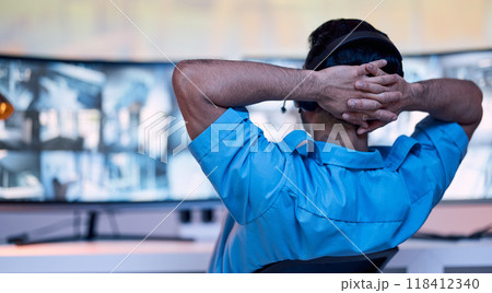 Security guard at desk, relax and cctv monitor for inspection service, building safety consultant and working at night. Screen, video surveillance agency and law officer in control room on late shift 118412340