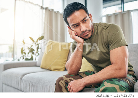 PTSD, anger or depression with a military man in uniform sitting on a sofa in the living room of his home. Mental health, stress or psychology with a male soldier thinking about a war memory PTSD, anger or depression with a military man in uniform sitting on a sofa in the living room of his home. Mental health, stress or psychology with a male soldier thinking about a war memory 118412378