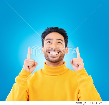 Happy, casual and man pointing up, promotion and winning against a blue studio background. Male person, guy or model with happiness, mockup space and decision with choice, excited and creative design Happy, casual and man pointing up, promotion and winning against a blue studio background. Male person, guy or model with happiness, mockup space and decision with choice, excited and creative design 118412406