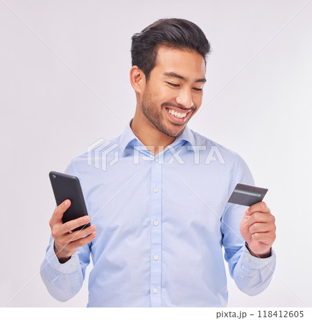 Man with smartphone, credit card and smile for ecommerce, fintech and online shopping isolated on white background. Payment, internet banking and technology with bank app and happy male in studio Man with smartphone, credit card and smile for ecommerce, fintech and online shopping isolated on white background. Payment, internet banking and technology with bank app and happy male in studio 118412605