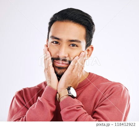 Portrait, shy and in love with a man in studio isolated on a white background while touching his cheeks. Face, coy and cute with a handsome young indian male feeling special on valentines day 118412922