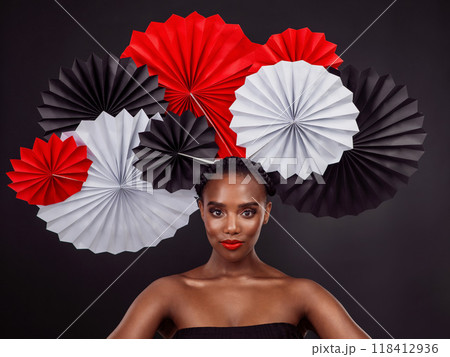Face, makeup and black woman with origami fans in studio isolated on a dark background. Serious portrait, beauty cosmetics and skincare of female model with traditional Japanese paper art for culture Face, makeup and black woman with origami fans in studio isolated on a dark background. Serious portrait, beauty cosmetics and skincare of female model with traditional Japanese paper art for culture 118412936