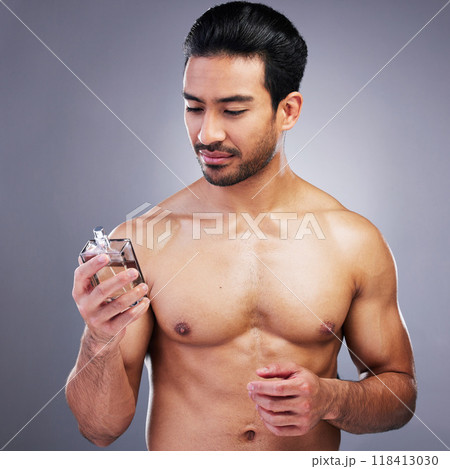 Topless, cosmetics or man with cologne for beauty or self care isolated on studio background. Wellness, male person or Asian model with luxury body perfume spray with fragrance bottle or grooming 118413030