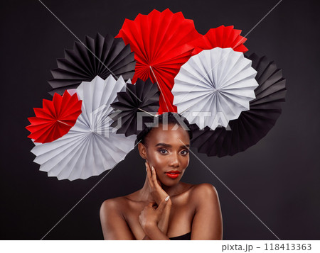 Beauty, portrait and black woman with origami fans in studio isolated on a dark background. Serious face, makeup cosmetics and skincare of female model with traditional Japanese paper art for culture 118413363