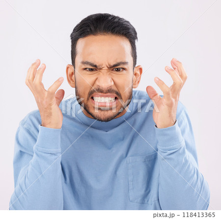 Mental health, anger and mad with a frustrated man in studio on a gray background feeling stress. Face, psychology and emotions with a young male person looking annoyed while gritting his teeth 118413365
