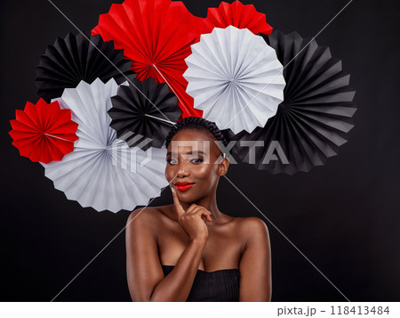 Beauty, portrait and black woman with origami fans in studio isolated on a dark background. Face, makeup cosmetics and skincare of female model with traditional Japanese paper art for culture hat. 118413484