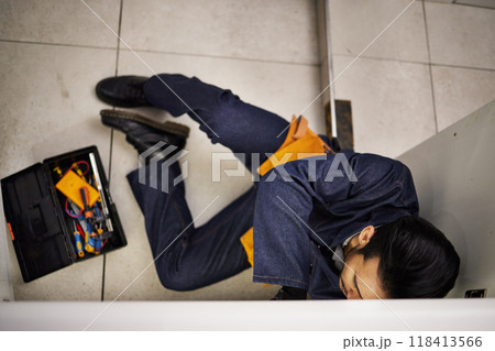 Plumbing, repair and maintenance with man in kitchen for man, industrial and inspection from above. Pipes, tools and safety with plumber fixing sink for home improvement, drainage and water system 118413566