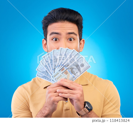 Money, shocked face and man with financial surprise, winning or savings mistake isolated on blue, studio background. Lottery, finance secret and asian person gambling, bonus and cashback in portrait 118413824