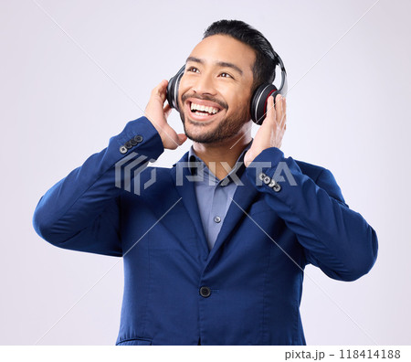 Executive man, music headphones and thinking on studio background of happiness, motivation and inspiration. Happy corporate worker listening to audio, sound and business podcast on radio with smile 118414188