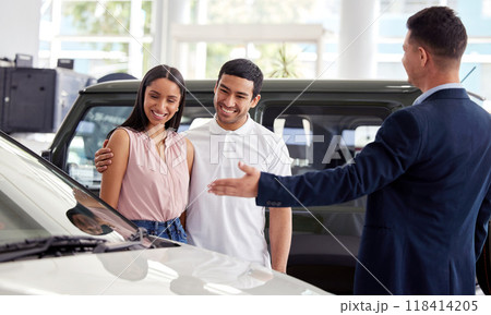 Couple at car dealership, choice and transportation with salesman, customer buying new transport with luxury. Sales, agreement and show cars with people at automobile showroom with purchase decision Couple at car dealership, choice and transportation with salesman, customer buying new transport with luxury. Sales, agreement and show cars with people at automobile showroom with purchase decision 118414205