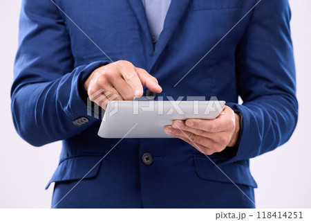 Man, tablet in hands and online in studio for communication with network connection on social media. Hand of business male typing for internet search, mobile app and chat with contact for marketing 118414251