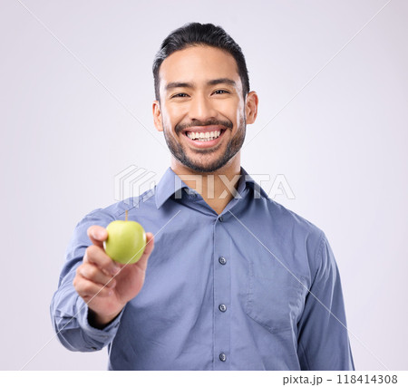 Apple, portrait and man happy with fruit for weight loss diet, studio healthcare or body detox. Wellness food, nutritionist lifestyle person and male vegan giving product isolated on gray background 118414308
