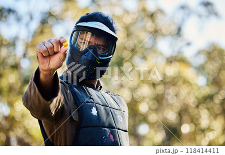 Man, paintball and hands holding ball on the battlefield for war, shot or engaging act in nature. Male paintballer or soldier showing or pinching paint bullet in military or extreme adrenaline sports Man, paintball and hands holding ball on the battlefield for war, shot or engaging act in nature. Male paintballer or soldier showing or pinching paint bullet in military or extreme adrenaline sports 118414411