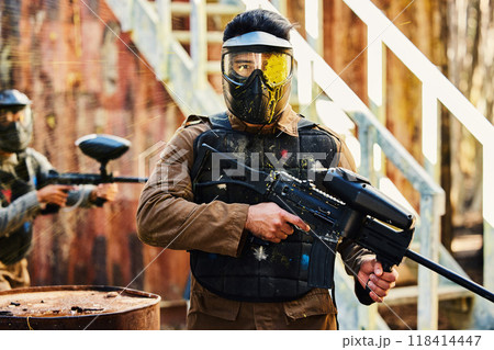 Portrait, paintball or man with gun in a game or competition for fitness, exercise or cardio workout. Focus, challenge or serious male athlete carrying an army weapon or marker for military training Portrait, paintball or man with gun in a game or competition for fitness, exercise or cardio workout. Focus, challenge or serious male athlete carrying an army weapon or marker for military training 118414447