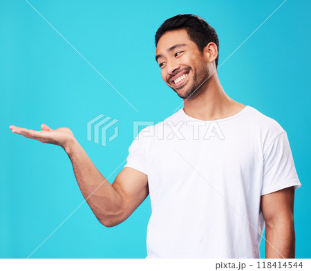 Mockup, showing and man with a smile, opportunity and decision against a blue studio background. Male person, advertising or model with promotion, hand gesture or presentation with thinking or choice 118414544