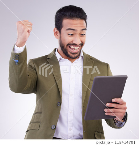 Success, winning and man on tablet isolated on studio background fist pump for business news or online bonus. Happy asian person or winner on digital tech with celebration for sale, prize or giveaway Success, winning and man on tablet isolated on studio background fist pump for business news or online bonus. Happy asian person or winner on digital tech with celebration for sale, prize or giveaway 118414701